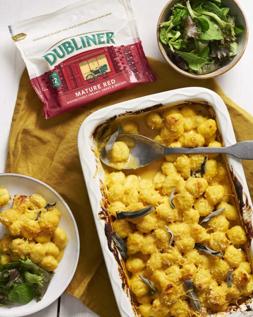 Baked Butternut Gnocchi in a baking dish alongside Dubliner Mature Red cheese pack