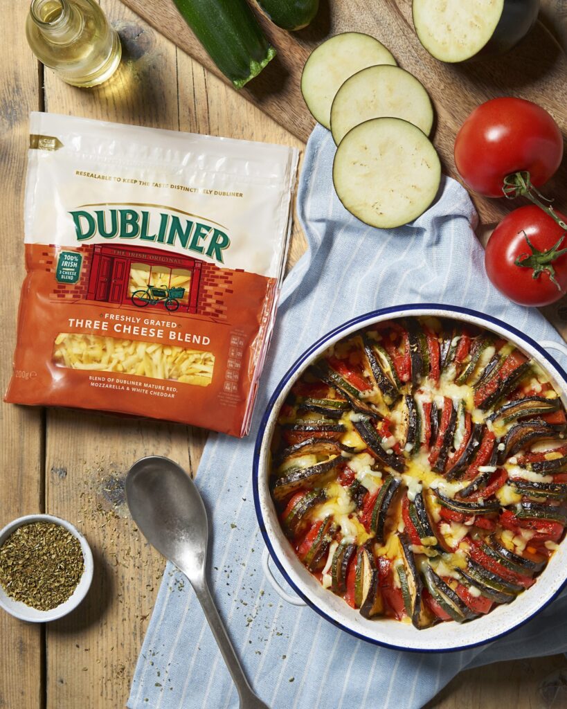 Cheesy Baked Ratatouille on a kitchen table alongside Dubliner Three Cheese Blend pack