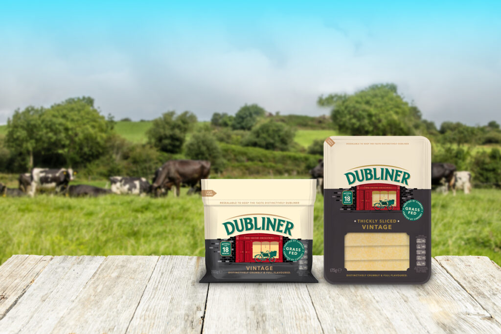 Packs from the Dubliner Vintage range in front of dairy field