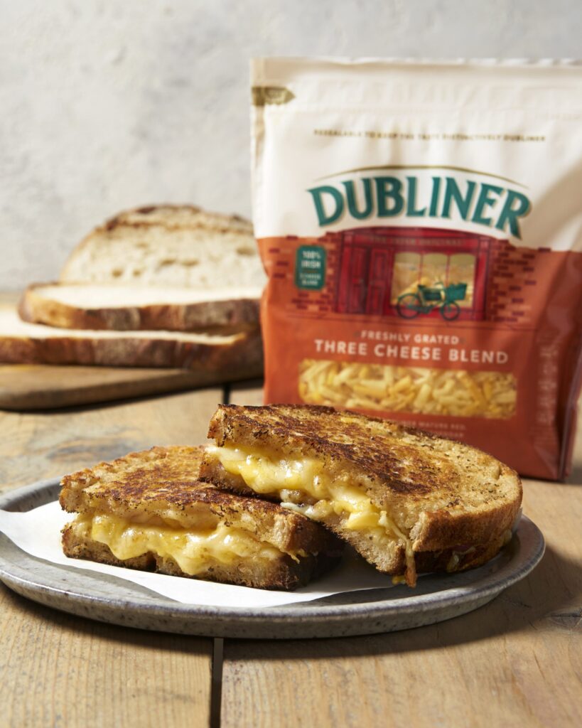 Dubliner Grilled Cheese Sandwich on wooden table in front of cheese pack